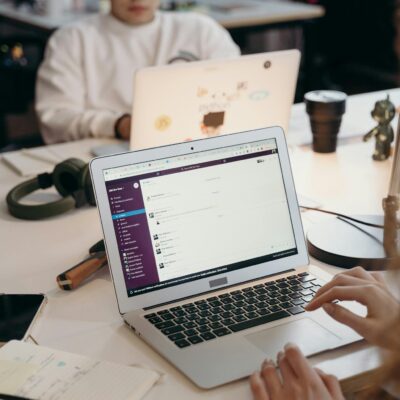 Professional team collaborating through digital tools in a contemporary office environment.